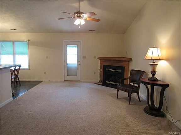 Family room with corner fireplace and vaulted ceiling