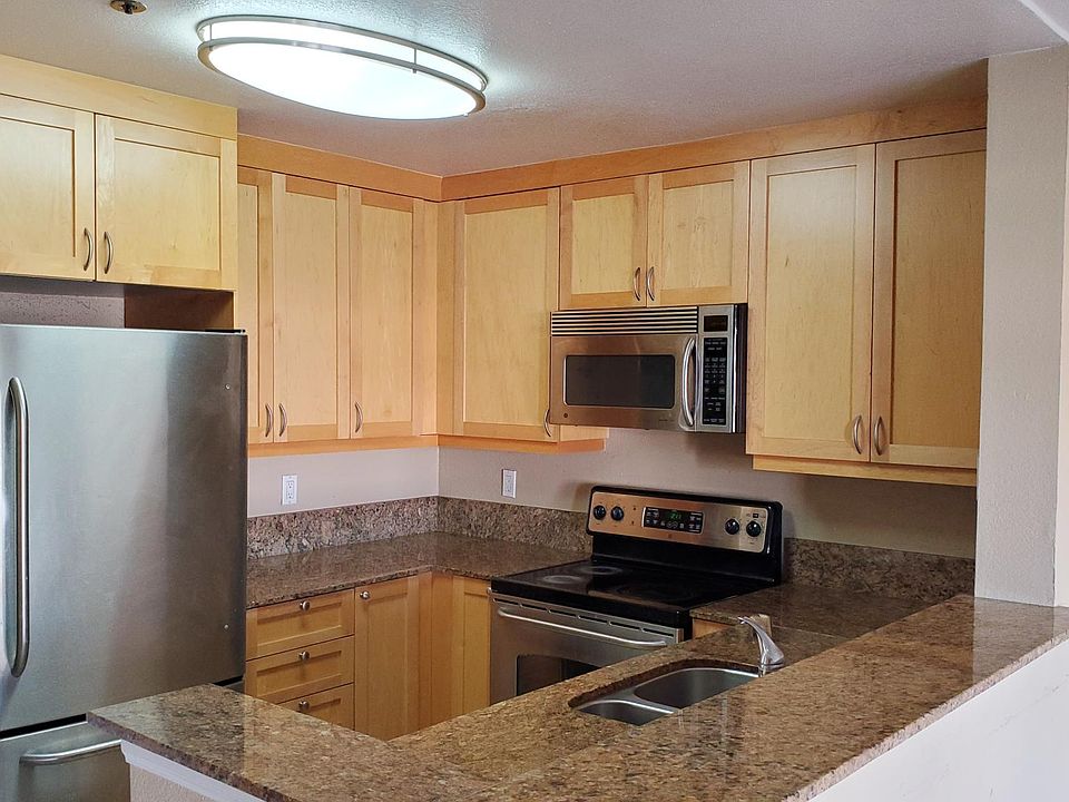 Custom kitchen cabinets, stainless steel appliances, granite counters