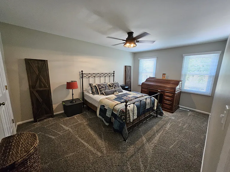 Master bedroom with ceiling fan and light