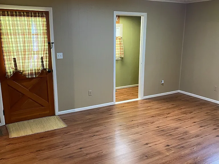 (2 of 2) Living room area with adjoining office space.