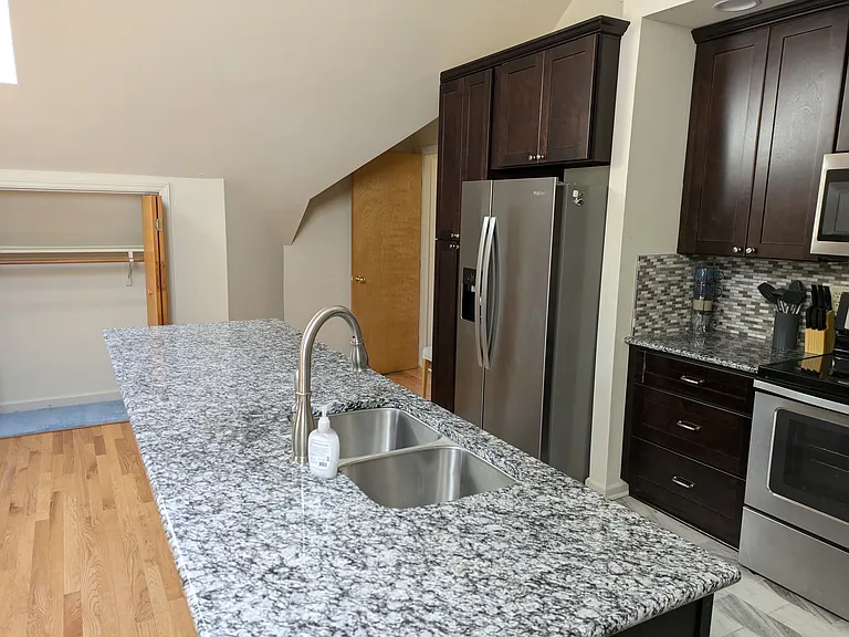 Granite kitchen counters, stainless appliances, many cabinets for storage