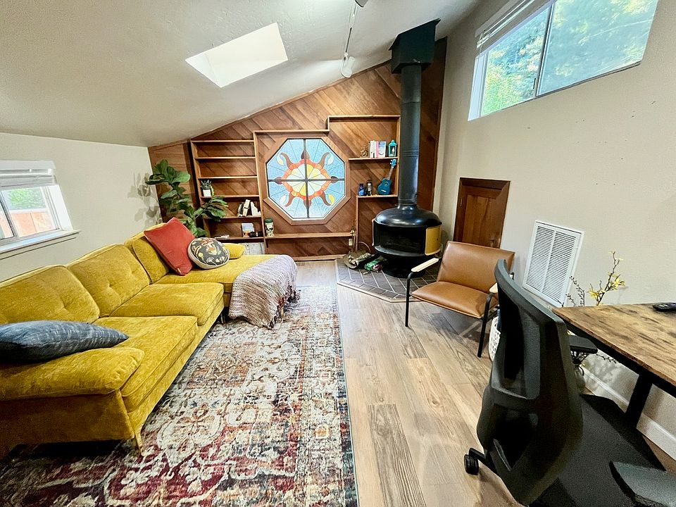 The upstairs living space features cathedral ceilings, a sky light and vintage stain glass window