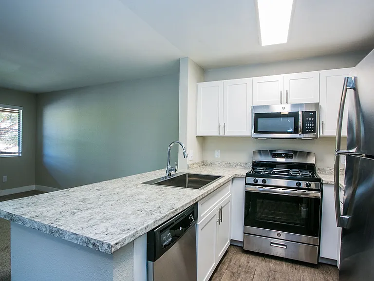 Granite breakfast bar overlooking living area.