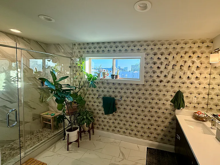Primary suite bathroom. View of UCity and Center City! Also, double sinks and big shower.