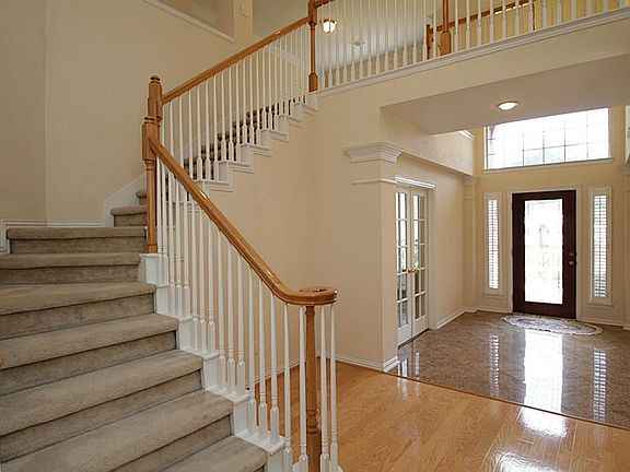 View of front door and stairway leading to upstairs Gameroom and three bedrooms.