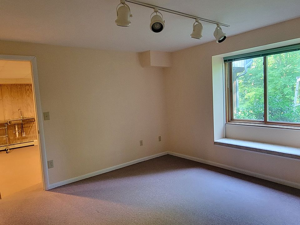 Bedroom with window overlooking yard and woods