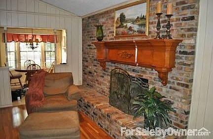 Family Room View 2 and Breakfast Area : Large brick gas fp, custom mantle, faux paint, wood flooring
