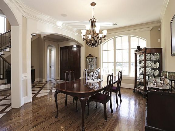 Dining room with graceful arches, hardwood flooring, decorative chandelier. Neutral paint colors throughout. This home is move in ready!