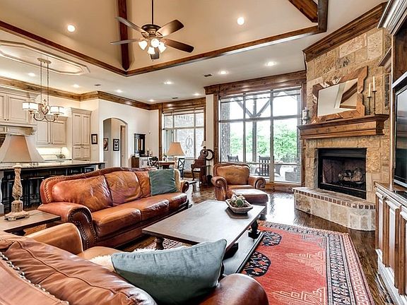 Beautifully appointed, open living area. Vaulted ceiling and exposed cedar beams. Hand scraped hardwood floors. 12 inch baseboards and crown moldings. Stone, floor to ceiling fireplace with gas logs. Built in entertainment center equipped for today's larg