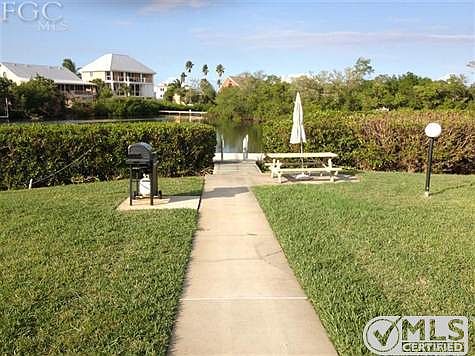 BARBECUE, PICNIC TABLE & ENTRANCE TO FLOATING DOCK AND WATER THAT IS SEEN FROM UNIT 161