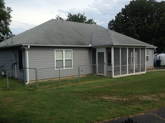 Porch entrance to fenced side yard.