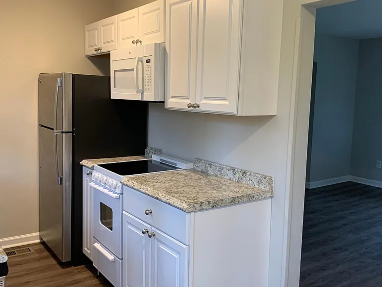 Update appliances including refrigerator, compact oven/stovetop and microwave.
