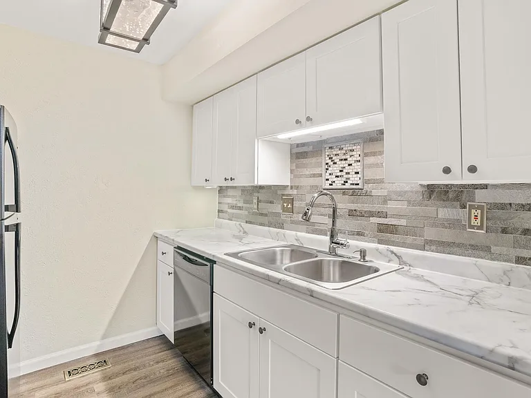 Kitchen with all new cabinets, refrigerator, stove, backsplash, and lighting; dishwasher and microwave