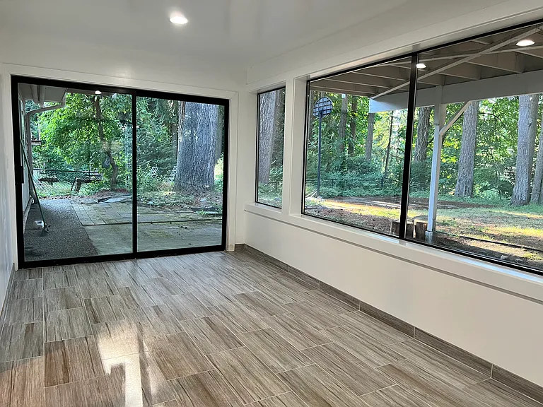 Enclosed sunroom offers versatile bonus space.