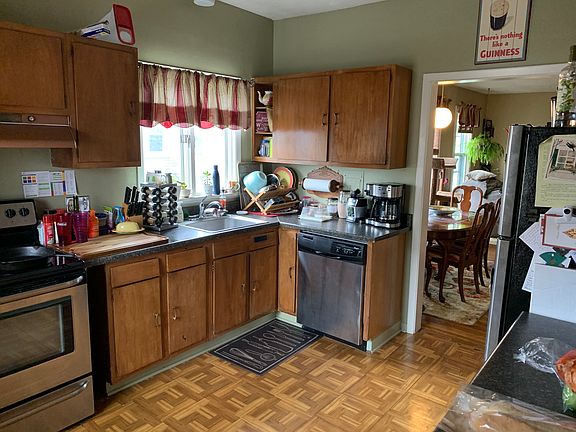 Large kitchen with stainless appliances and plentiful wood cabinets, much large than the average apartment.