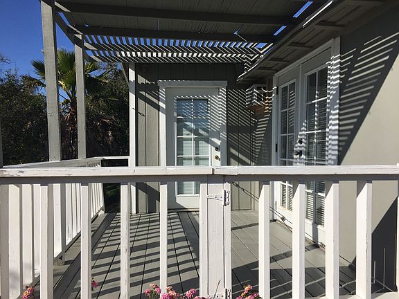 Private deck reached through living room, bedroom, or yard.