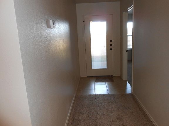 Hallway to backyard, Door has blinds in between glass so as to open or close.