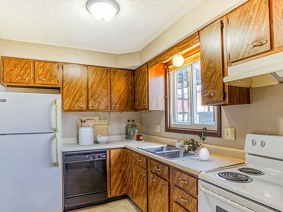 Kitchen wood cabinets white appliances large window