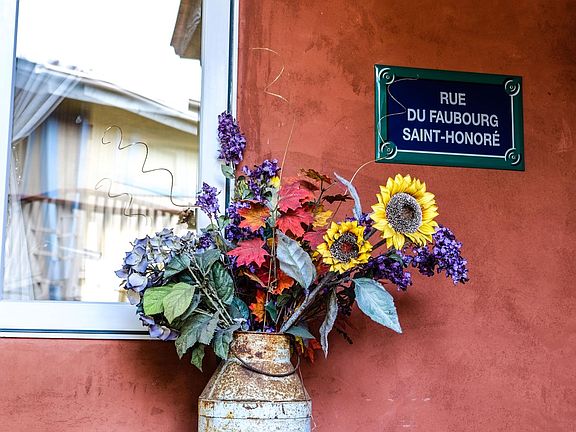 French arrangement at entry door. Milk bucket brought back from France by local artist.