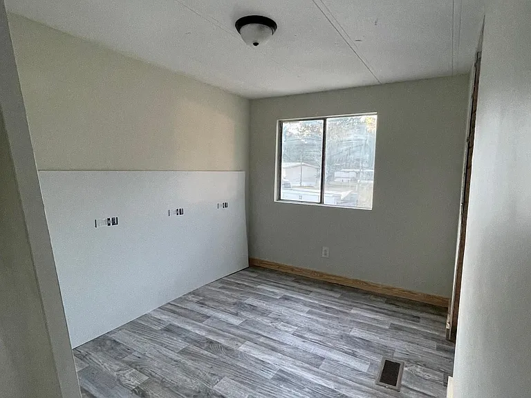 Freshly primed/painted, new flooring and lighting in mid-home guest bedroom as well.