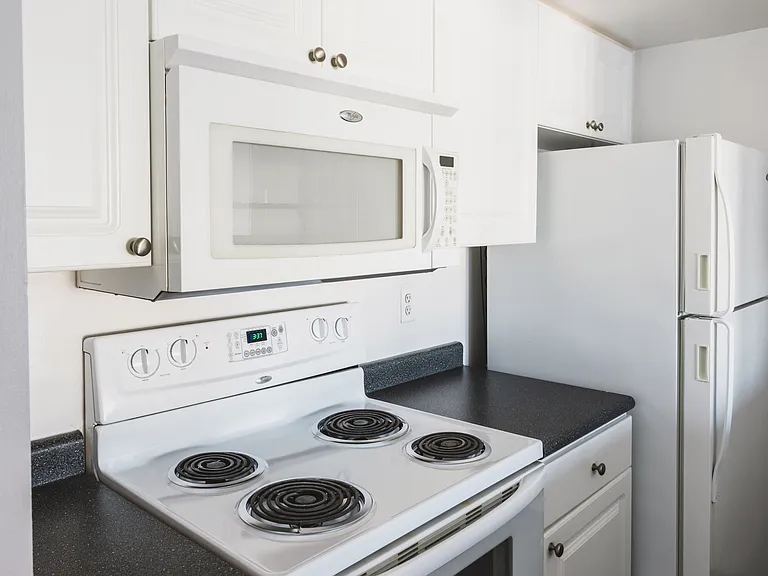 Upgraded white cabinetry and appliances and granite-look counters in select NW tower homes