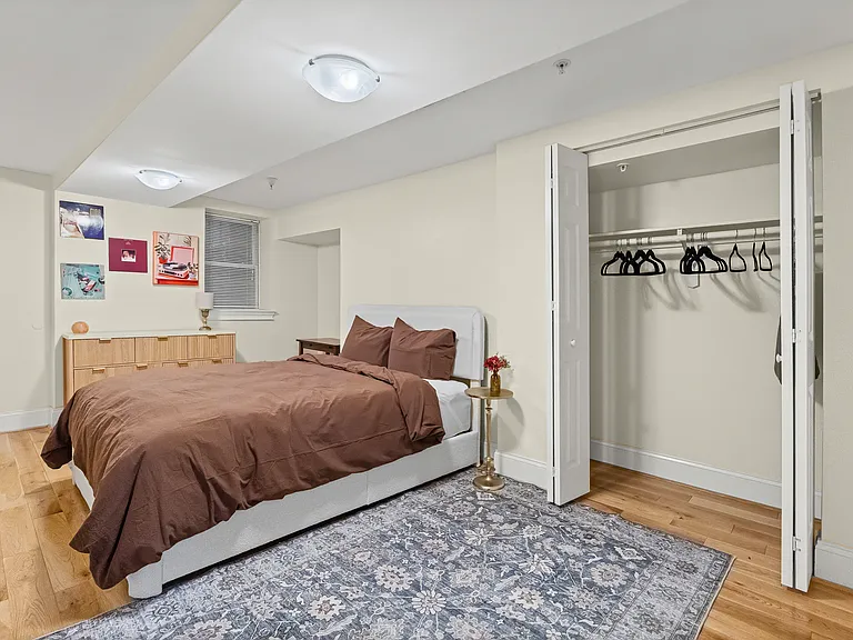 Spacious bedroom with two closets and dresser.