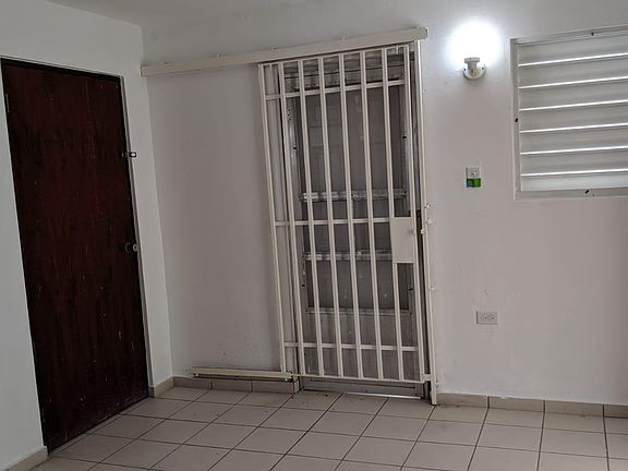 Entrance door is gated on the inside.