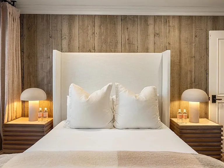 Retreat to the bedroom, where coastal comfort invites peaceful slumber.