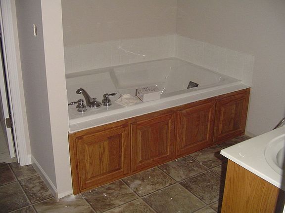 The master bath includes a jetted tub, double vanity and a walk-in closet
