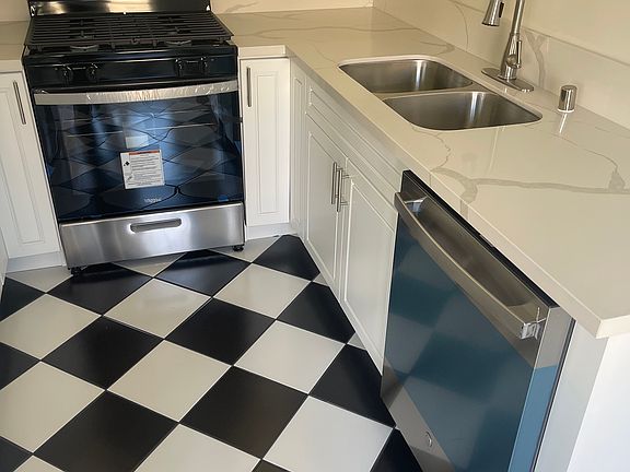 Brand new kitchen and appliances, including dishwasher, gas range, built-in microwave, fridge, garbage disposal