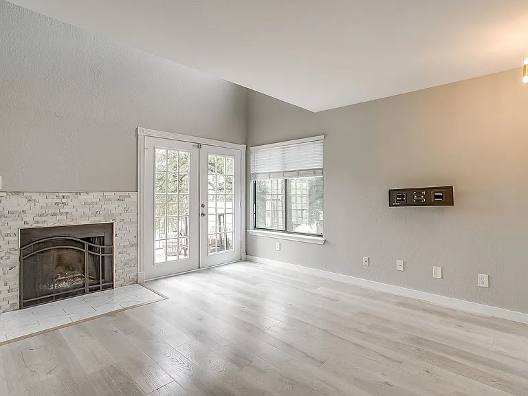 Living area with wood-burning fireplace and a balcony!