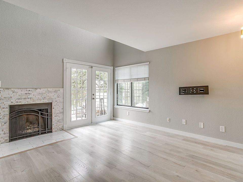 Living area with wood-burning fireplace and a balcony!