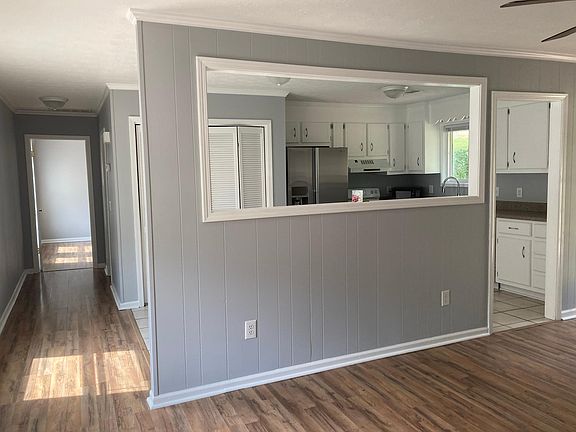 View into kitchen and hallway to master bedroom.