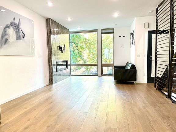 Sun-drenched living room with large windows and abundant natural light