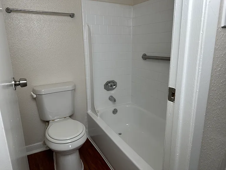 Modern bathroom with a sleek bathtub and pristine white tiles creating a fresh and clean atmosphere. Modern bathroom with a sleek bathtub and pristine white tiles creating a fresh and clean atmosphere.