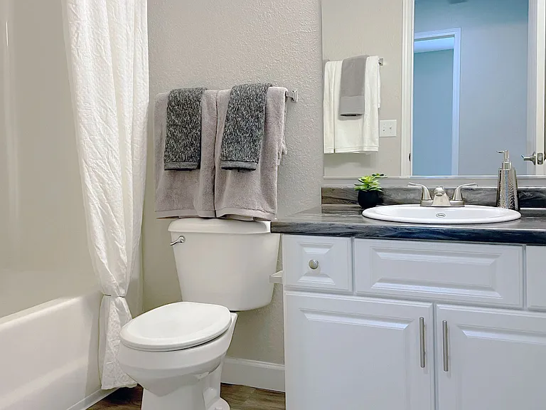 Clean, functional bathrooms feature a full bathtub for comfortable bathing, professionally operated by Highlands Vista Group.
