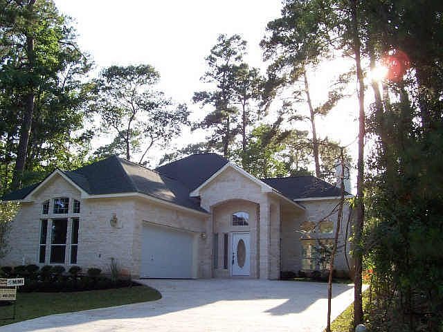 White stone exterior between two vacant lots on 11th hole of Walden GC