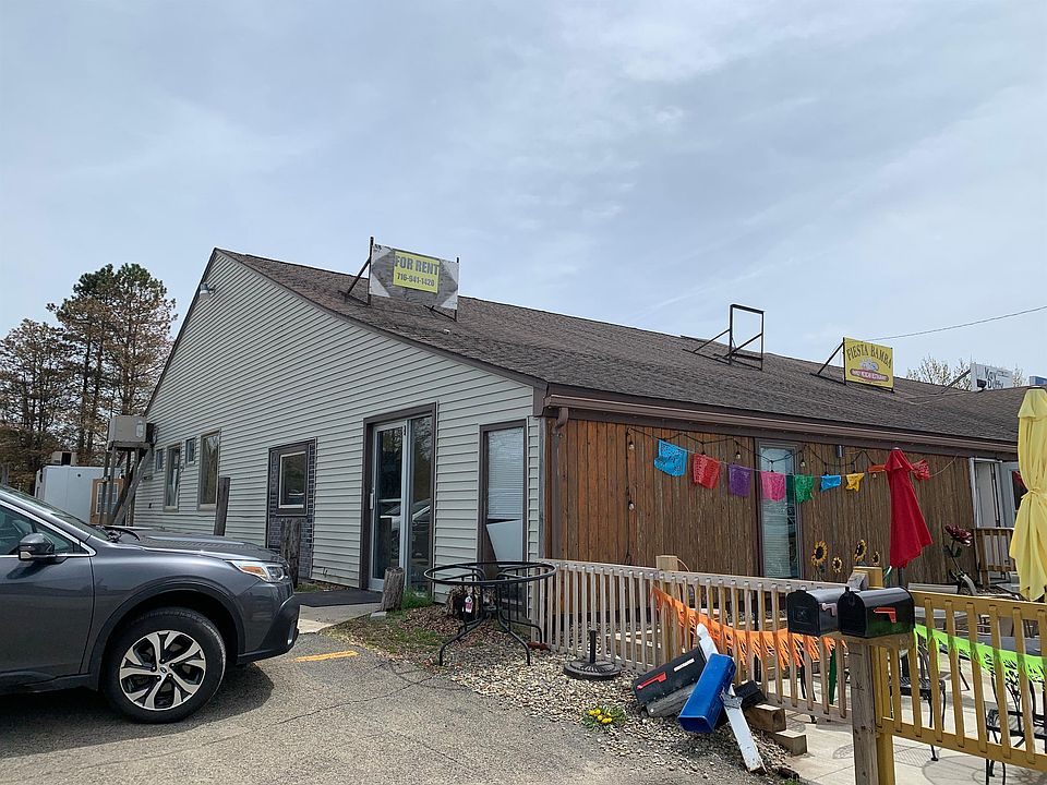 Entrance is located to the left next to the restaurant patio.