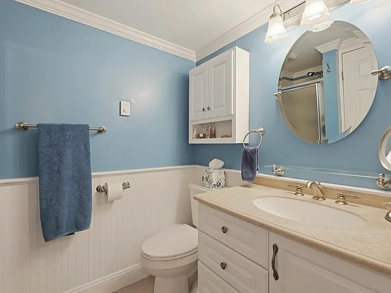 Ensuite bathroom for Bedroom #2, with shower. Features a closet containing the washing machine and dryer