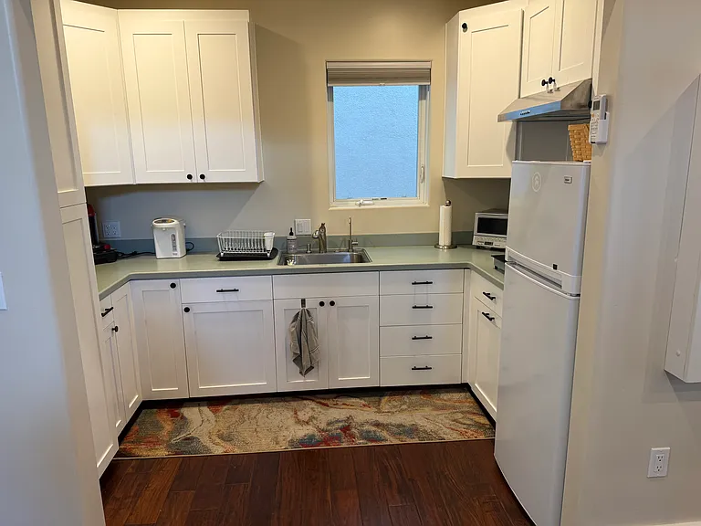 Kitchenette has fridge, toaster, air fryer, microwave, 2 burner stove top with hood, plenty of storage (no oven).