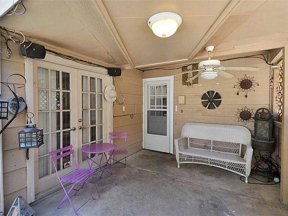 Relax and plan your outdoor meals under your covered patio space. Note the ceiling fan and speakers.
