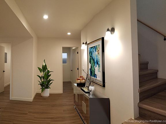 View into the house, across the foyer from the front door, and virtually staged to demonstrate its potential.