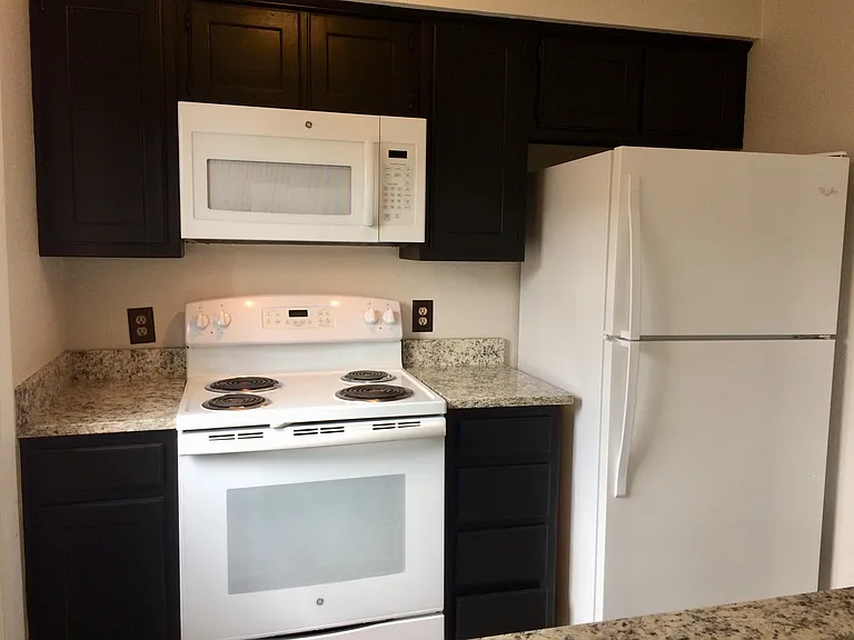 Built in microwave, refrigerator and 4 burner electric stove.