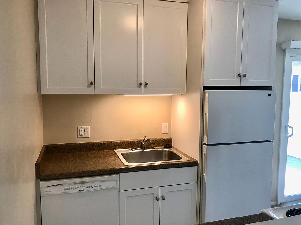 The kitchen has a dishwasher, sink with under counter light, and refrigerator.