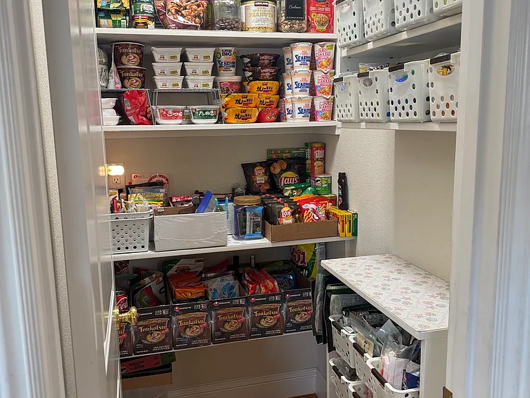 Pantry-Exceptionally organized pantry shelves featuring a wide-clearance layout for effortless access.