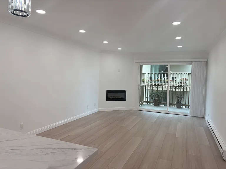 Luxury Vinyl Flooring throughout, and an electric fireplace. Large sliding glass doors