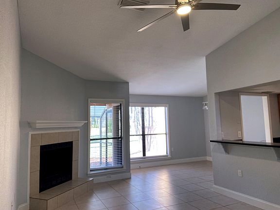 Enter into this spacious living area with vaulted ceilings and wood burning fireplace.