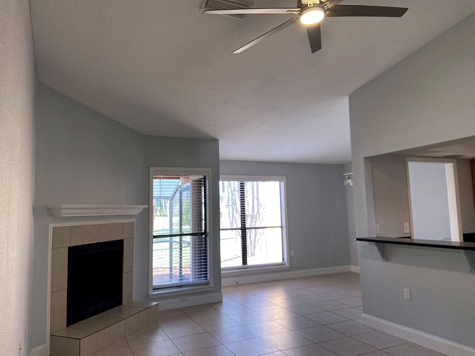 Enter into this spacious living area with vaulted ceilings and wood burning fireplace.
