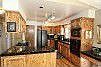 The kitchen features beautiful cabinets and hardwood floors