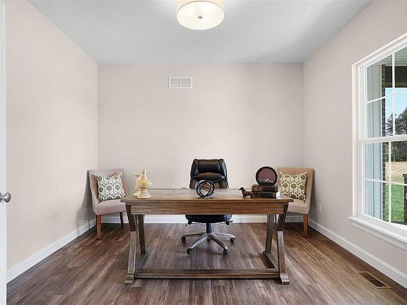 Study off the entry foyer with glass French doors and natural lighting.